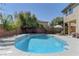 An inviting backyard pool offers a relaxing escape, complemented by lush greenery and ample lounging space at 9992 Sky Parlor Rd, Las Vegas, NV 89178
