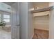 Walk-in closet near the bathroom has carpeted floors and closet organizers at 9992 Sky Parlor Rd, Las Vegas, NV 89178