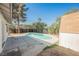 Backyard featuring a refreshing pool, partial fence, and mature landscaping at 10 Yew Ave, Las Vegas, NV 89110