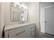 Well-lit bathroom featuring a vanity with white cabinets and drawers, a sink, and a mirror at 10 Yew Ave, Las Vegas, NV 89110