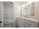 Bright bathroom featuring a vanity with white cabinets and drawers, sink, and a shower-tub combo at 10 Yew Ave, Las Vegas, NV 89110