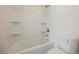 Clean bathroom featuring a shower-tub combo, white walls, and a toilet at 10 Yew Ave, Las Vegas, NV 89110