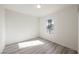 Clean bedroom with a window providing natural light and a view of palm trees at 10 Yew Ave, Las Vegas, NV 89110