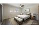 Primary bedroom featuring neutral decor, plush bedding and hardwood floors and modern lighting at 10 Yew Ave, Las Vegas, NV 89110