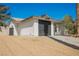 Charming exterior featuring a neutral color scheme, an attached garage, and gravel landscaping at 10 Yew Ave, Las Vegas, NV 89110