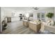 Open concept living room with dining and kitchen and views of the backyard pool through French doors at 10 Yew Ave, Las Vegas, NV 89110