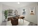 Cozy office space featuring decor, shelves, a desk, and natural light from the window at 10 Yew Ave, Las Vegas, NV 89110