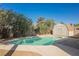 Backyard pool with a storage shed surrounded by lush green landscaping creating a relaxing outdoor space at 10 Yew Ave, Las Vegas, NV 89110