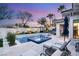 Serene backyard showcasing a modern pool, elegant landscaping, and comfortable lounging space at 10717 Beringer Dr, Las Vegas, NV 89144