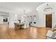 Open-concept dining room featuring wood floors, large windows, and stylish decor at 10717 Beringer Dr, Las Vegas, NV 89144