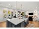 Spacious kitchen with large island, stylish pendant lights, stainless steel appliances and an open floor plan at 10717 Beringer Dr, Las Vegas, NV 89144