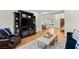 Living area with hardwood floors, tv set on bookcase and access to the dining room at 10717 Beringer Dr, Las Vegas, NV 89144