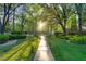 Beautiful street view with mature trees creating a canopy, enhancing the curb appeal and peaceful ambiance at 10717 Beringer Dr, Las Vegas, NV 89144