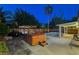 Backyard with a hot tub, string lights, outdoor seating, and palm trees, perfect for relaxation at 1078 Sandstone Canyon St, Henderson, NV 89012