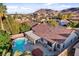 Aerial view of a private backyard with a pool, hot tub, covered patio, and lush landscaping, perfect for outdoor living at 1078 Sandstone Canyon St, Henderson, NV 89012