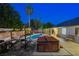 Backyard featuring a pool, hot tub, outdoor seating, and lush landscaping, great for outdoor living at 1078 Sandstone Canyon St, Henderson, NV 89012