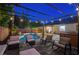 Outdoor living space with a pool, hot tub, string lights, and comfortable seating area at 1078 Sandstone Canyon St, Henderson, NV 89012