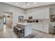 Contemporary kitchen featuring white cabinetry, a central island with seating, and wood flooring at 1078 Sandstone Canyon St, Henderson, NV 89012