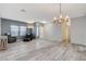Bright living room featuring stylish lighting, neutral paint, wood-look floors, and comfortable seating at 1078 Sandstone Canyon St, Henderson, NV 89012