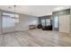 Bright living room with wood-look floors, neutral paint, modern lighting, and a large window at 1078 Sandstone Canyon St, Henderson, NV 89012