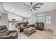 Bright living room boasts wood floors, recessed lighting, and comfortable gray leather furniture at 1078 Sandstone Canyon St, Henderson, NV 89012