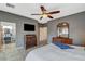 Relaxing main bedroom featuring wood flooring, a large window, and access to bathroom at 1078 Sandstone Canyon St, Henderson, NV 89012