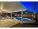 Inviting backyard pool with covered patio, seating area, and mature landscaping, perfect for relaxing and entertaining at 1078 Sandstone Canyon St, Henderson, NV 89012