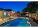 Sparkling kidney-shaped pool with an inviting spa, outdoor seating, and lush tropical landscaping creating an oasis at 1078 Sandstone Canyon St, Henderson, NV 89012