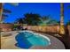 Backyard view of the kidney-shaped pool, spa, outdoor seating area with mature palms and brick perimeter fence at 1078 Sandstone Canyon St, Henderson, NV 89012