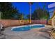 Backyard at dusk featuring a pool, lounge chairs, and desert landscaping, ideal for evening relaxation at 1078 Sandstone Canyon St, Henderson, NV 89012