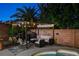 Outdoor seating area featuring comfy patio furniture, privacy, and relaxing string lights near the pool and spa at 1078 Sandstone Canyon St, Henderson, NV 89012