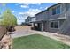 This backyard has grass, rocks, and concrete tiles, all surrounded by a brick wall at 10925 Jordyn Hill St, Las Vegas, NV 89141