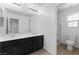 This bathroom features double sinks, dark wood cabinets, and a walk-in shower at 10925 Jordyn Hill St, Las Vegas, NV 89141