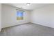 This bedroom has neutral paint and carpet, along with a large window to let in natural light at 10925 Jordyn Hill St, Las Vegas, NV 89141