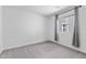 Bright bedroom with neutral walls, a window with curtains, and plush carpeting at 10925 Jordyn Hill St, Las Vegas, NV 89141