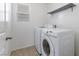 This laundry room features a side-by-side washer and dryer, a small window, and a shelf at 10925 Jordyn Hill St, Las Vegas, NV 89141