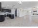 Open-concept living room with a view of the modern kitchen and fireplace at 10925 Jordyn Hill St, Las Vegas, NV 89141