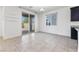 Bright living room with sliding glass doors leading to a patio and adjacent kitchen space at 10925 Jordyn Hill St, Las Vegas, NV 89141