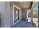 This patio has a brick floor with a sliding glass door and concrete columns at 10925 Jordyn Hill St, Las Vegas, NV 89141