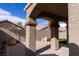 View of back patio with paver flooring, stucco columns, and an arched covered area at 1100 Warm Canyon Way, Las Vegas, NV 89123