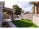 A backyard featuring synthetic grass, paver patios, and stucco privacy walls at 1100 Warm Canyon Way, Las Vegas, NV 89123