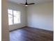 Bedroom featuring wood-look floors, window, and ceiling fan at 1100 Warm Canyon Way, Las Vegas, NV 89123