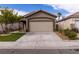 Charming single-story home with desert landscaping, two-car garage, and covered front porch at 1100 Warm Canyon Way, Las Vegas, NV 89123