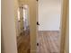 View of a hallway with wood flooring and white doors at 1100 Warm Canyon Way, Las Vegas, NV 89123