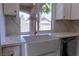 Bright kitchen view featuring white cabinets, a large farmhouse sink, and natural light at 1100 Warm Canyon Way, Las Vegas, NV 89123