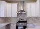 Beautiful kitchen showcasing white cabinets, stone countertops, and a stainless steel hood at 1100 Warm Canyon Way, Las Vegas, NV 89123