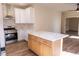 Open kitchen with white cabinets, marble counters, and stainless steel appliances at 1100 Warm Canyon Way, Las Vegas, NV 89123
