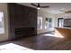 Bright living room boasts an electric fireplace, ceiling fan, and beautiful wood floors at 1100 Warm Canyon Way, Las Vegas, NV 89123