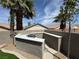 An outdoor kitchen with a built-in grill and counter space with privacy walls at 1100 Warm Canyon Way, Las Vegas, NV 89123