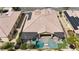 Birds-eye view featuring a home with solar panels, a pergola, a pool and spa amid a landscaped backyard at 11274 Felice Cohn Ct, Las Vegas, NV 89179
